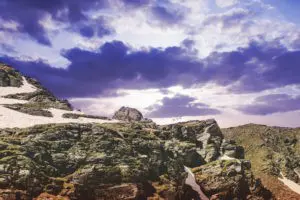A rocky hill with a sky background